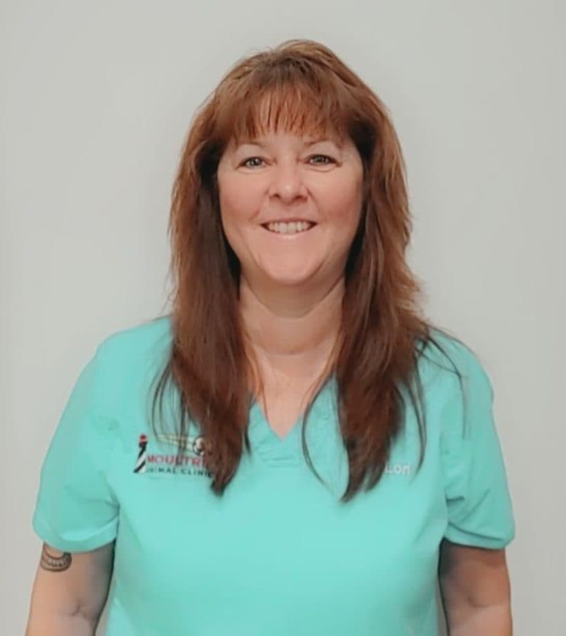 Lori in teal Moultrie Animal Clinic scrubs.