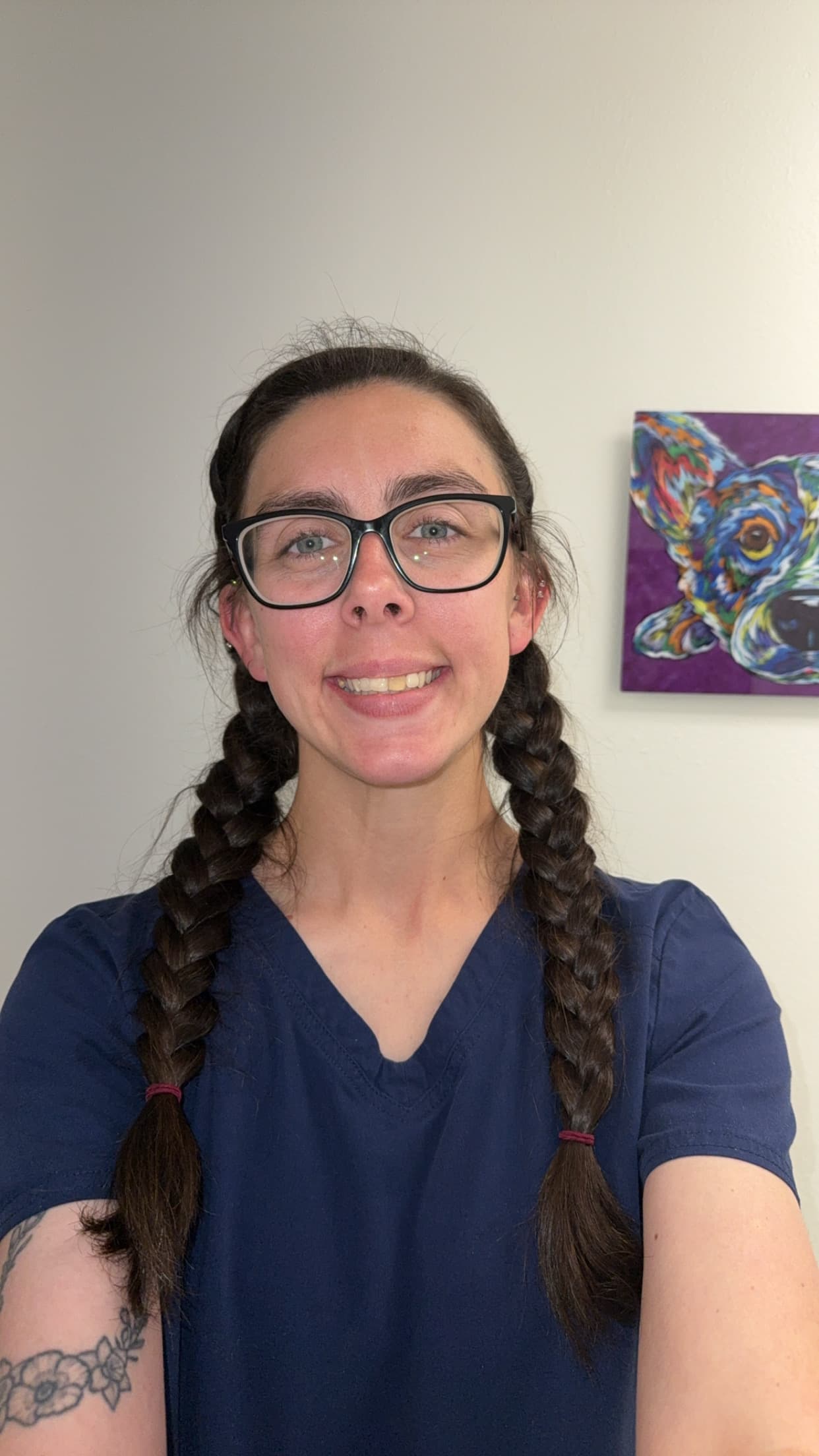 Megan wearing dark blue scrubs.