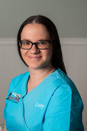 Casey in blue Moultrie Animal Clinic scrubs.